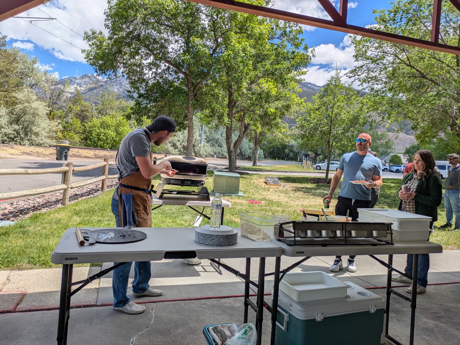 Cooking fresh pizzas for guests with a Utah mountain backdrop